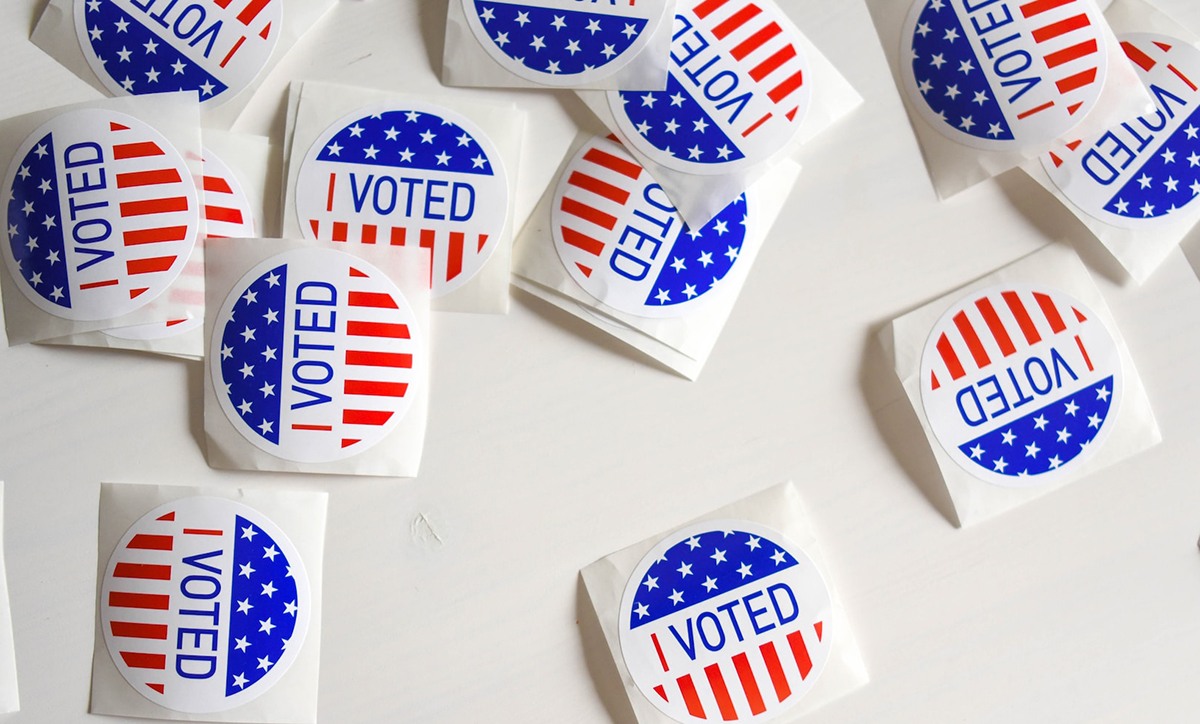 Photo of a batch of "I Voted" stickers spread out on a white surface. 