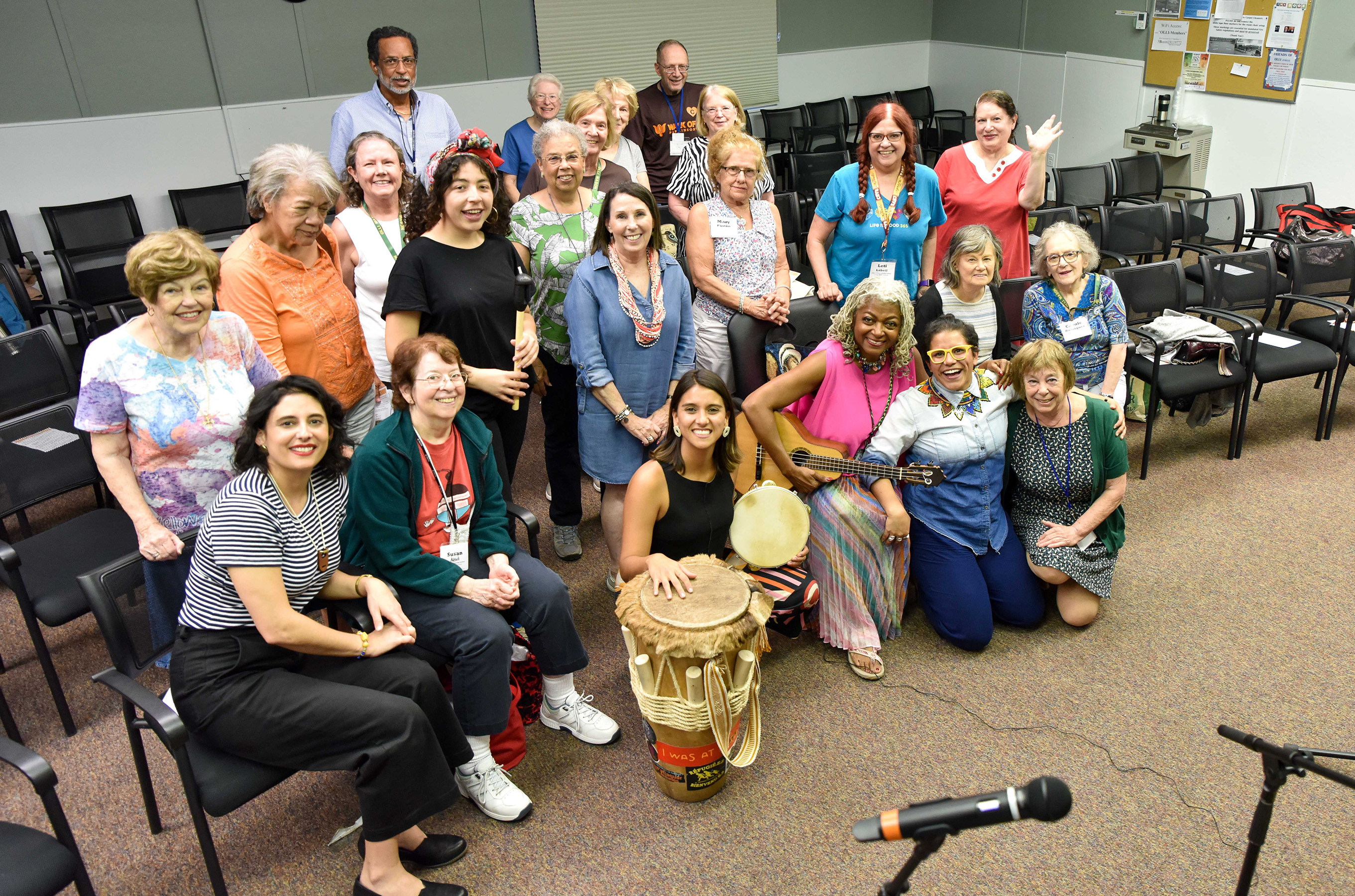 Photo of OLLI participants in a room with chairs and musical instruments.