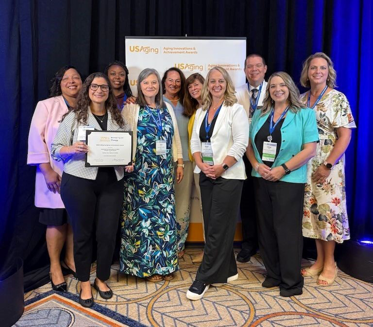 AAA and ElderLink staff pose together with their USAging Achievement Award.