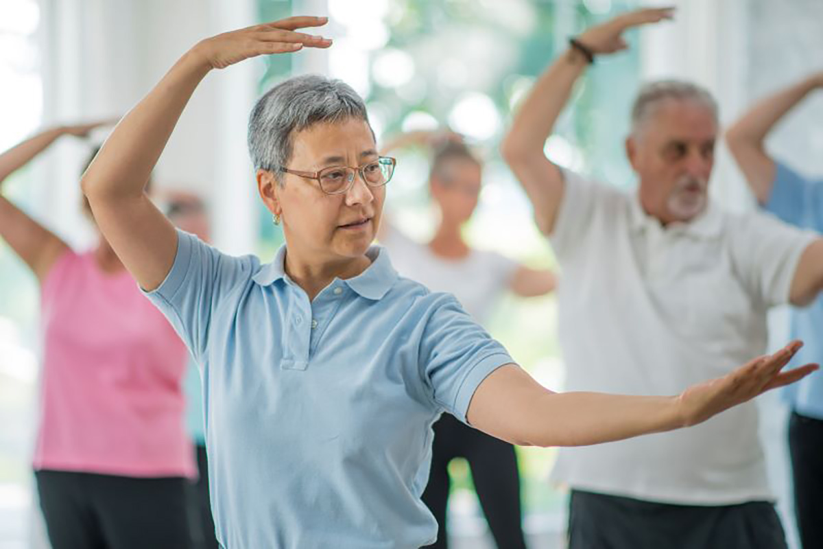 Older adults engage in a Tai Chi class.