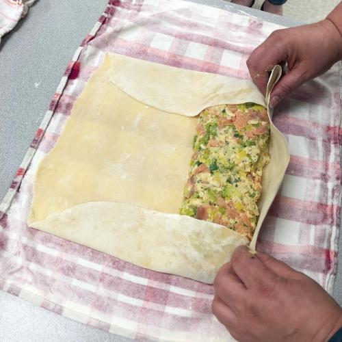 person rolling dough