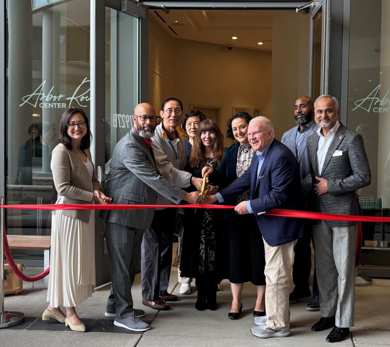 Dignitaries cut a ribbon to open the new Arbor Row Center in Tysons.