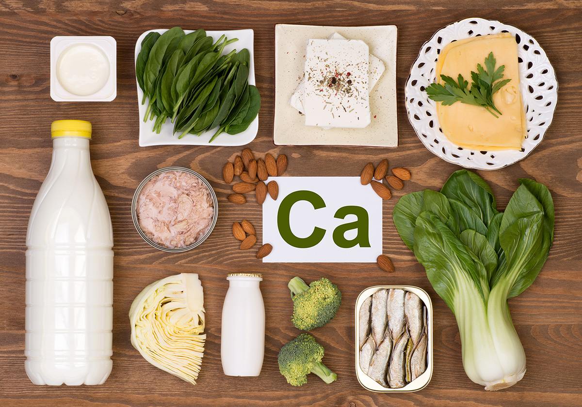 Photo of foods that are good sources of calcium, including dairy and leafy greens.