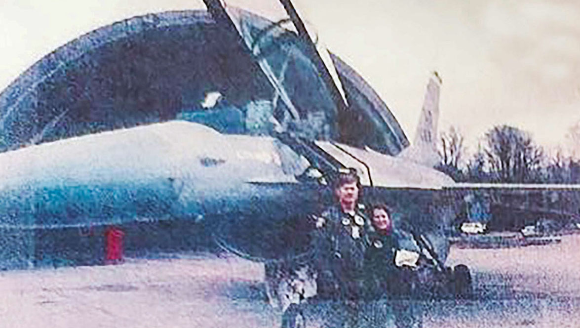 Photo of Diana Artemis and a pilot standing in front of a F-16 fighter jet after a flight.