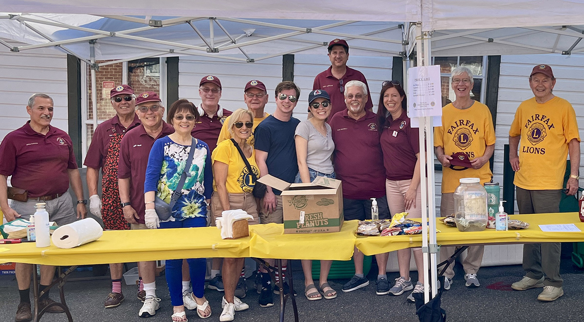 Fairfax Lions Club members working at their food booth and the City of Fairfax's Independence Day parade.