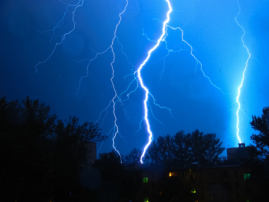 Night sky with bolts of lightning streaking down.