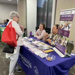 older woman at Older Adults information table