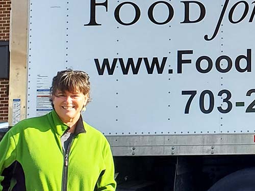 Tracy Griggs standing next to delivery truck