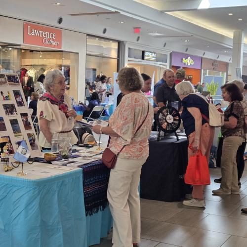 volunteer talking to fair attendee