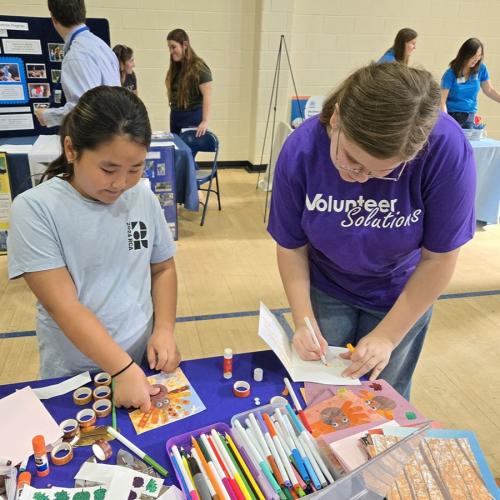 Annika and young girl making cards