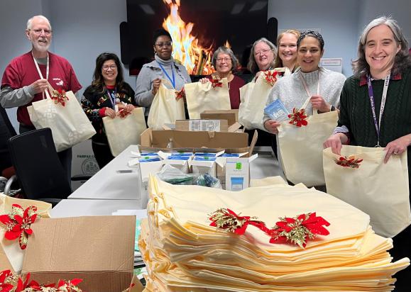 group of people holding gift bags