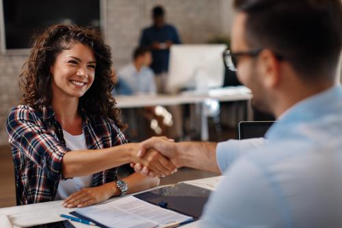 woman shaking man hand