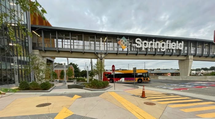 Bridge with "Springfield" sign crosses over traffic lanes and sidewalks.