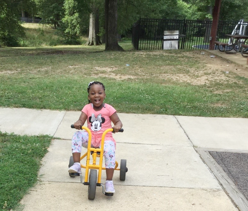 Little girl on tricycle