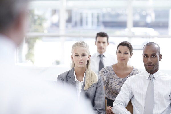 Adults at meeting listening to speaker