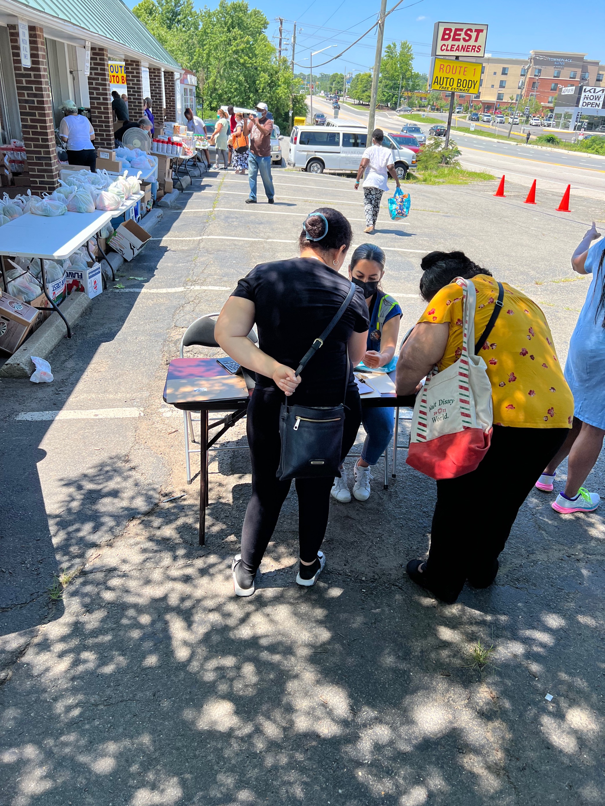 Community health worker assisting people at food distribution event