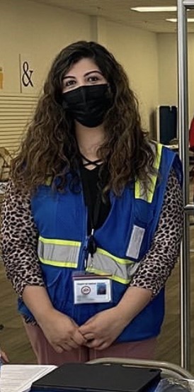 Vaccine navigator in blue vest outside clinic