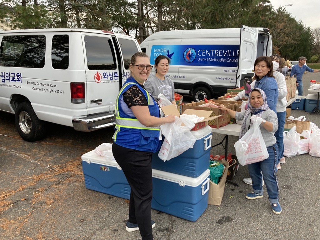 Staff members putting together bags of food 