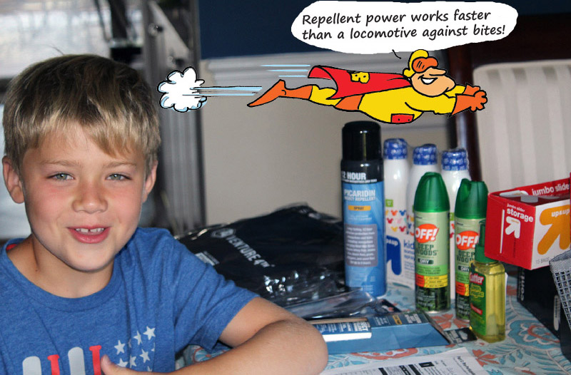 Young boy seated next to an assortment of repellents