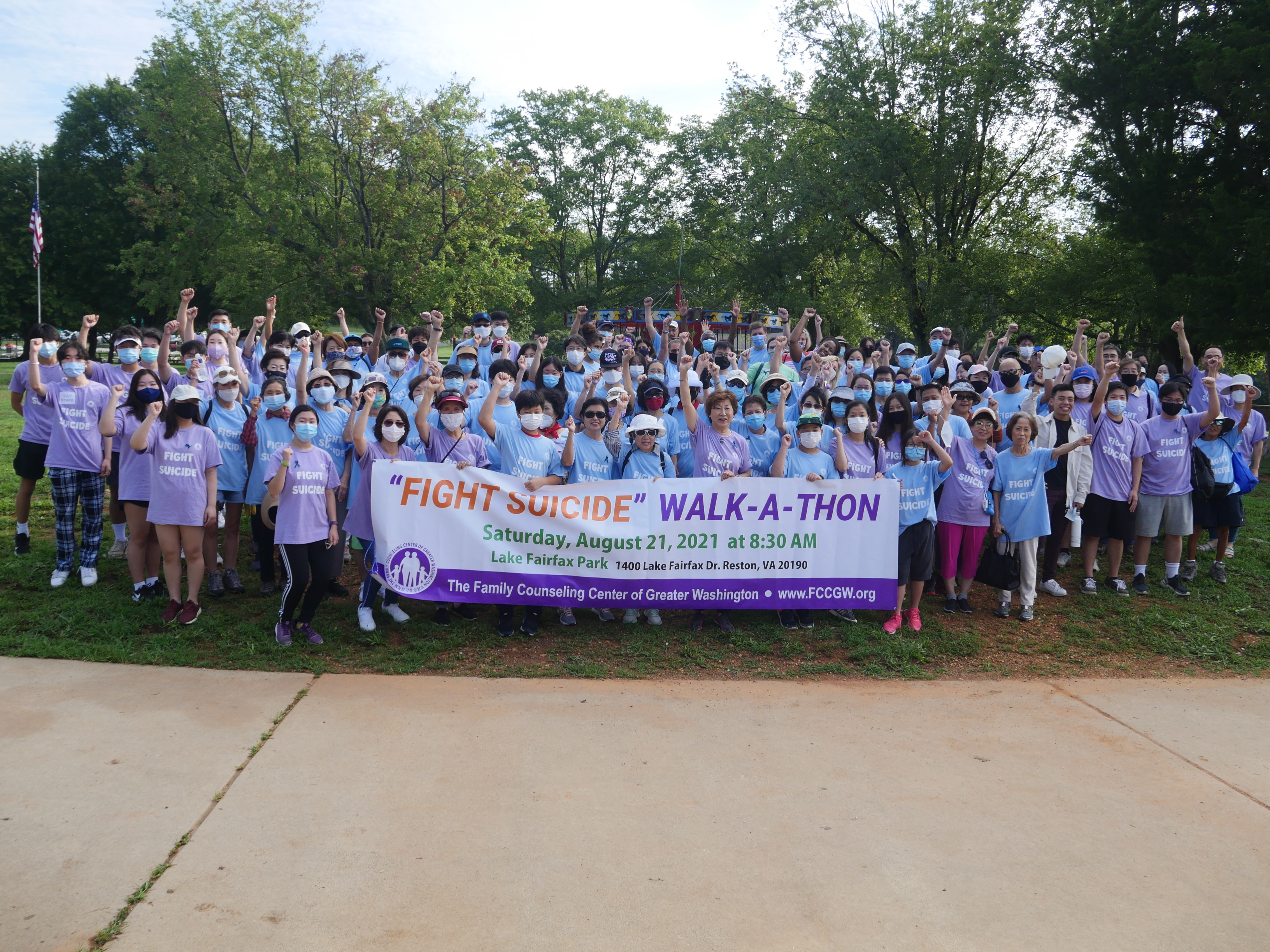 Large group of people outside with a "'Fight Suicide' Walk-a-thon" banner