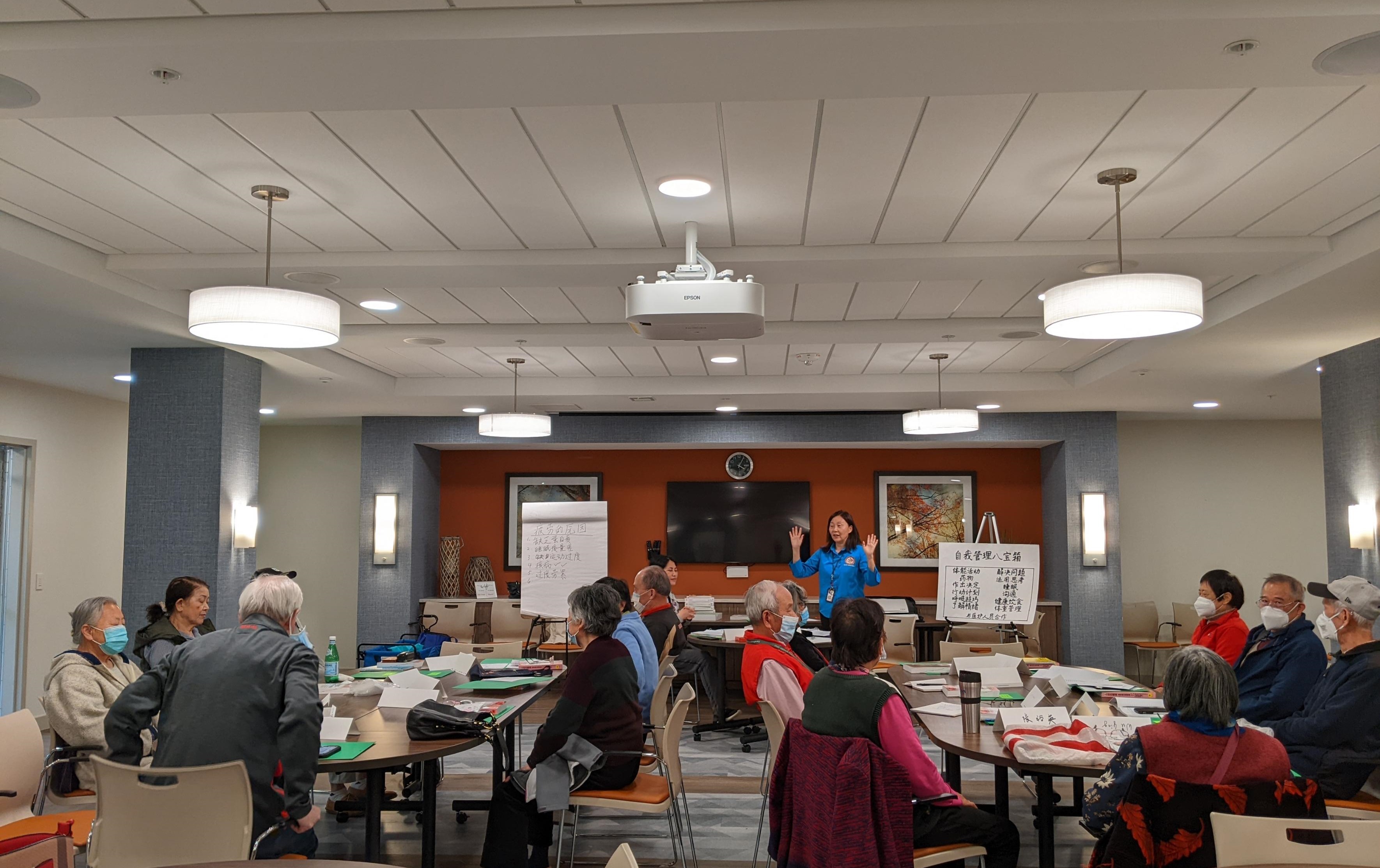 Ms. Yang leading a Chronic Disease Self-Management Program workshop for seniors at Lake Anne House 