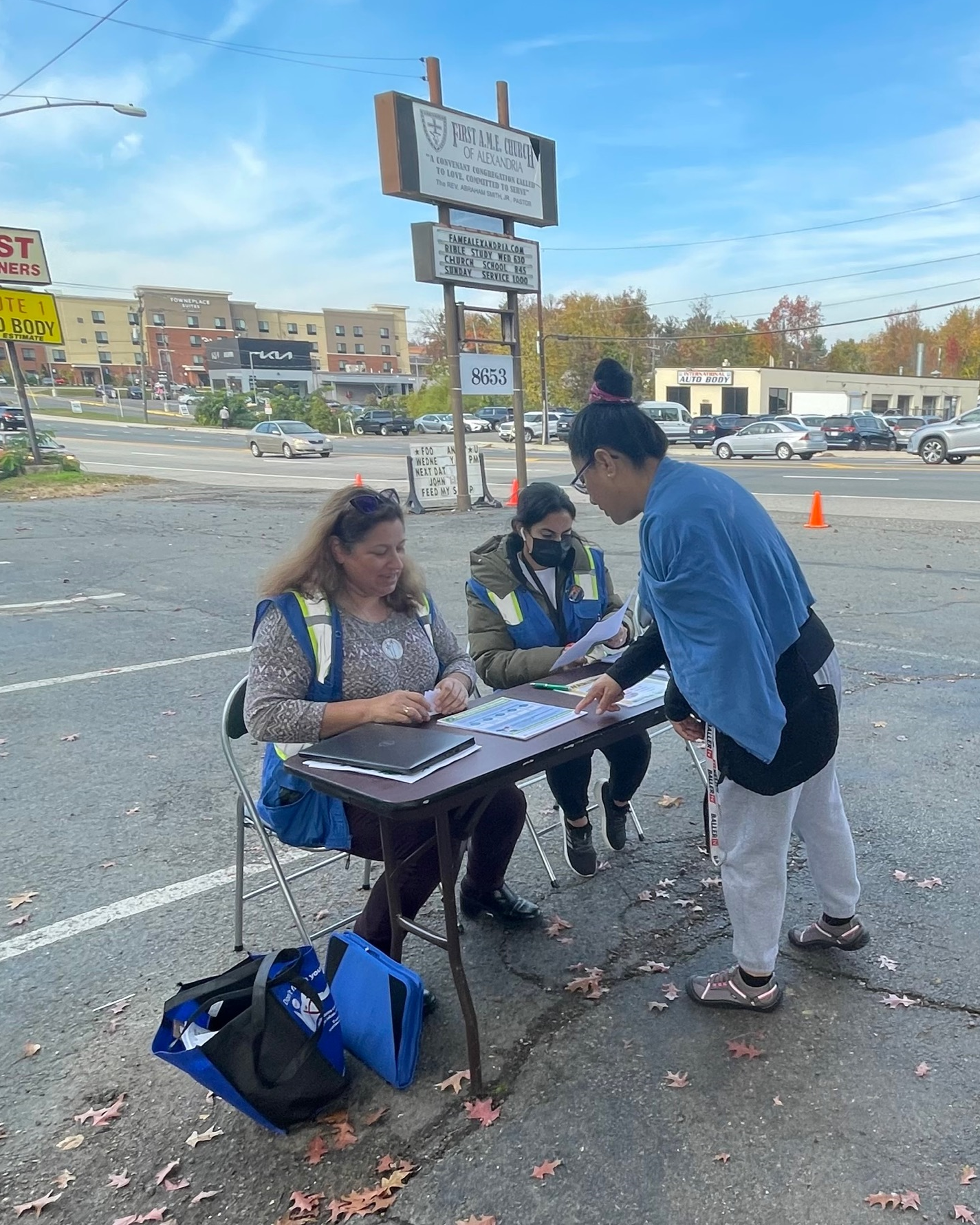 Community health workers outside at information table