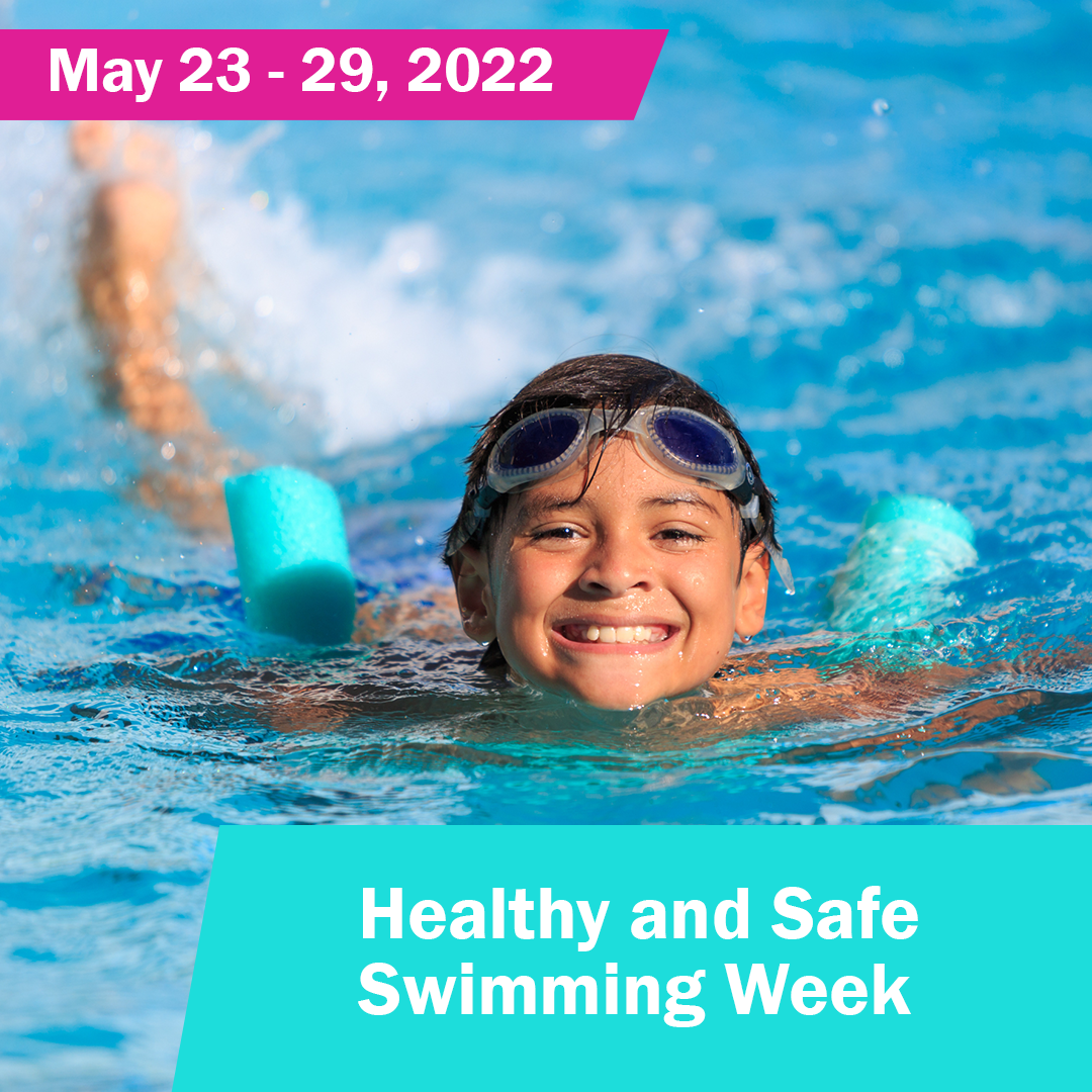 May 23-29, 2022. Healthy and Safe Swimming Week. Image: a smiling boy wearing goggles on his head while swimming in a pool with a pool noodle.