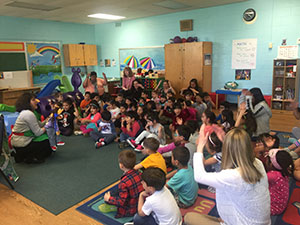 Christine Carlock performs a puppet show at Main Street Child Care Development Center to promote vaccinations for kids.