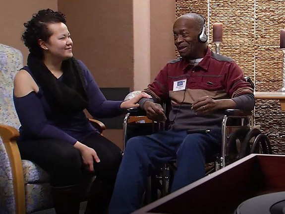 Music and Memory coordinator Stephanie gets participant Bill set up with his playlist