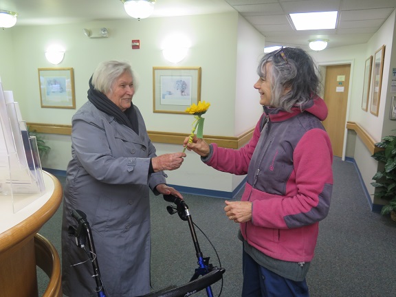 Adult Day Health Care participant gives her caregiver a flower