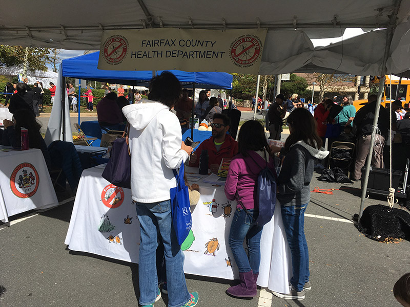 Disease Carrying Insect Program staff mans a table at a community event