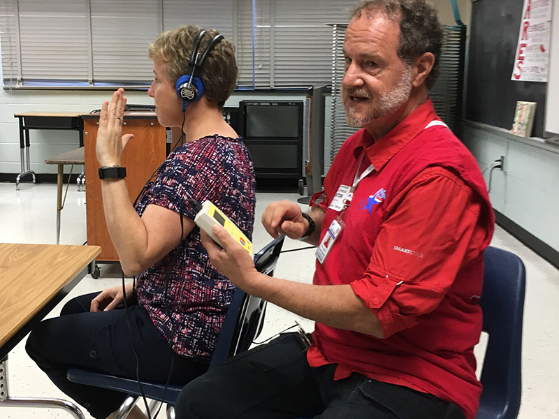 MRC volunteer conducts a hearing screening