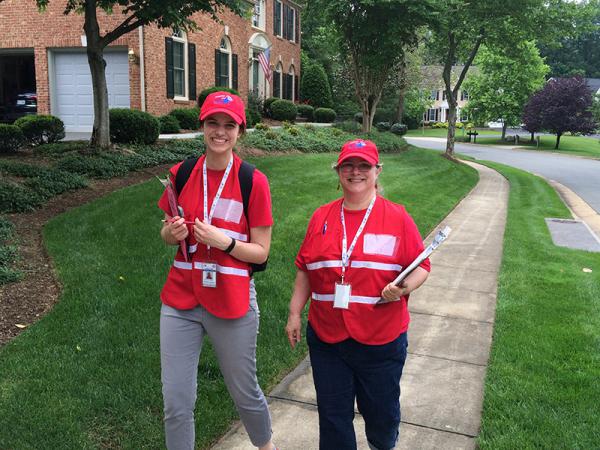 Two female MRC volunteers walking in a neighborhood