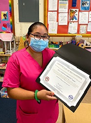 ACCA Child Development Center of Annandale staff member holds Certificate of Recognition 