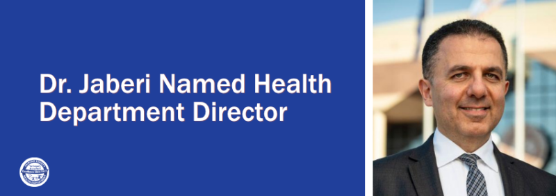 Graphic reading “Jaberi Named Health Department Director” beside a portrait of a smiling man in a suit and tie.