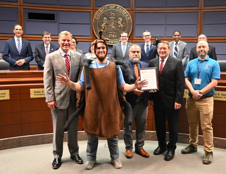 The Board of Supervisors and Disease Carrying Insects Program staff pose with the Fight the Bite Proclamation and tick mascot.