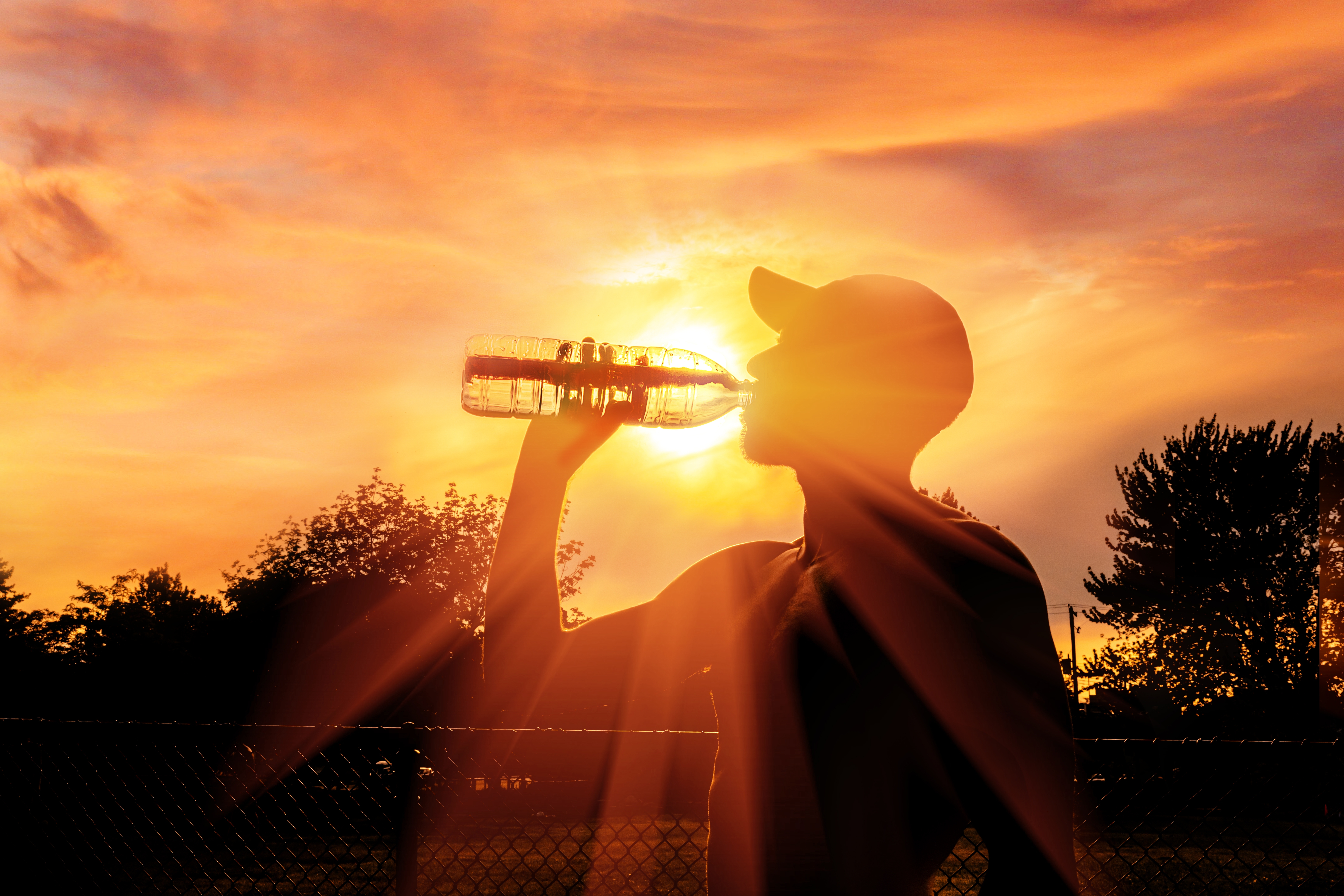 Person drinking water in sunshine