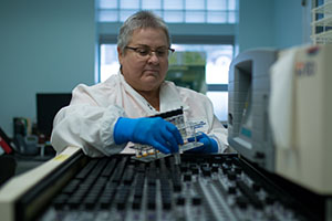 Mary Louise Kolodziej works with equipment in the laboratory