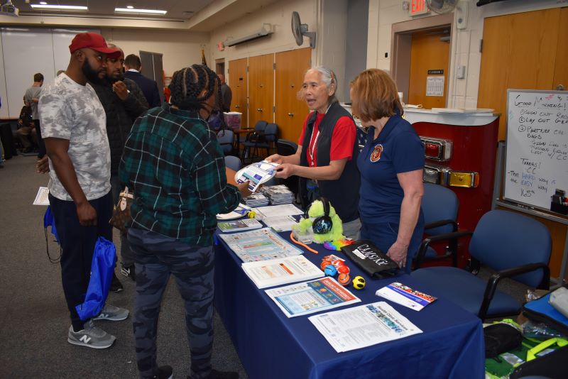health department reps talk to event attendees