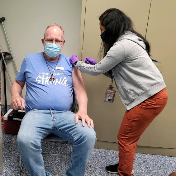 Nathalie Washington providing an immunization.