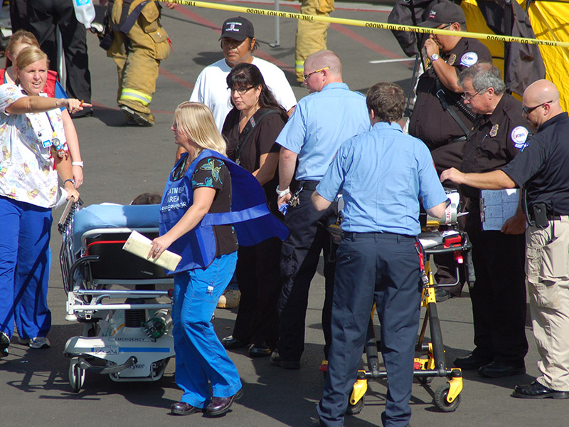 Hospital staff and HAZMAT personnel evacuate patients