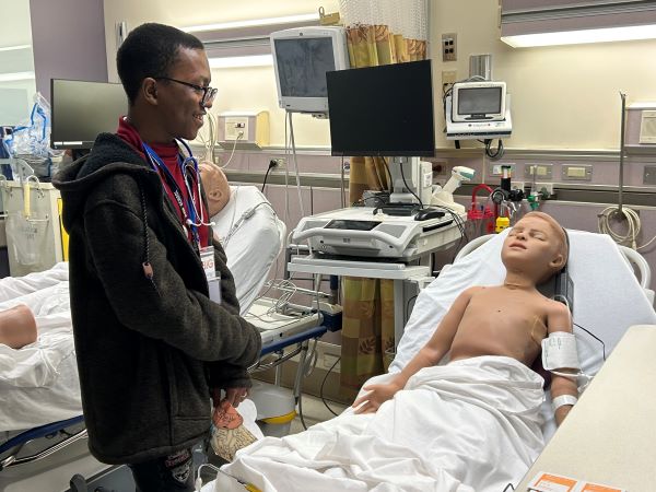 student with training mannequin
