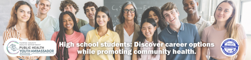 Eleven diverse high school students and their teacher pose in front of the chalkboard in a classroom