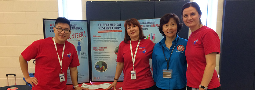 Volunteers posed for a picture while staffing an MRC table