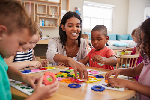 Preschool teacher working with students