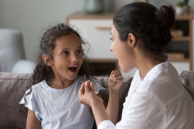 young girl working with a speech therapist