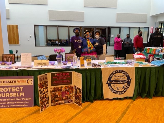 Health Department staff and partners at information table at the event