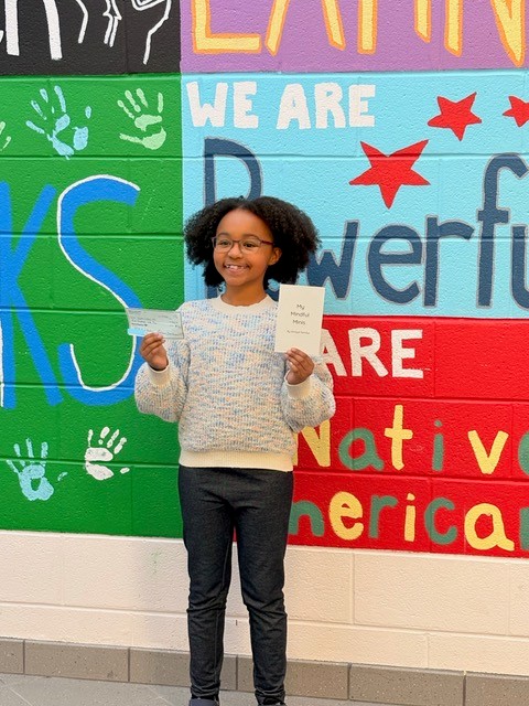 Amaya Samba presenting a $500 check to the South Lakes Food Pantry
