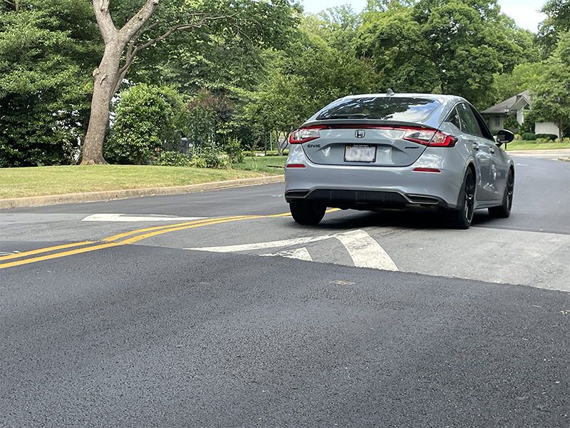 Car driving over speed hump