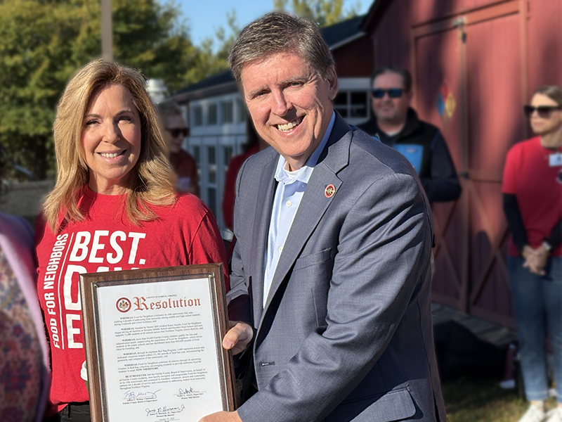Supervisor Walter Alcorn presenting a proclamation to Food for Neighbors founder Karen Joseph